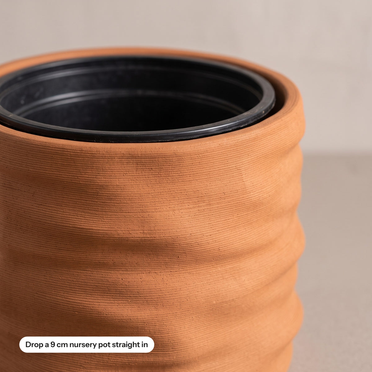 Close-up of the planter rim with a nursery pot dropped inside