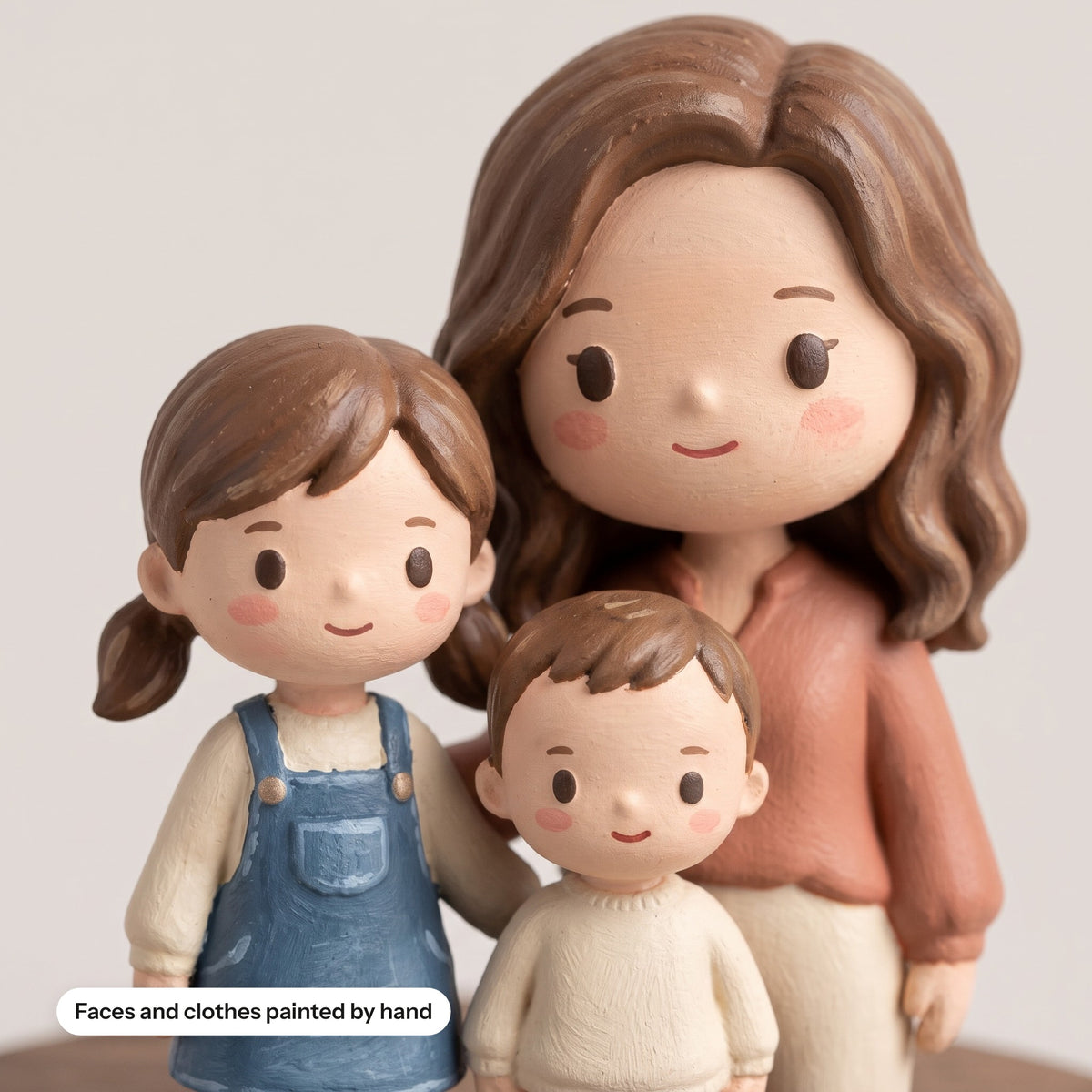 Close-up of the hand-painted faces on a family figurine