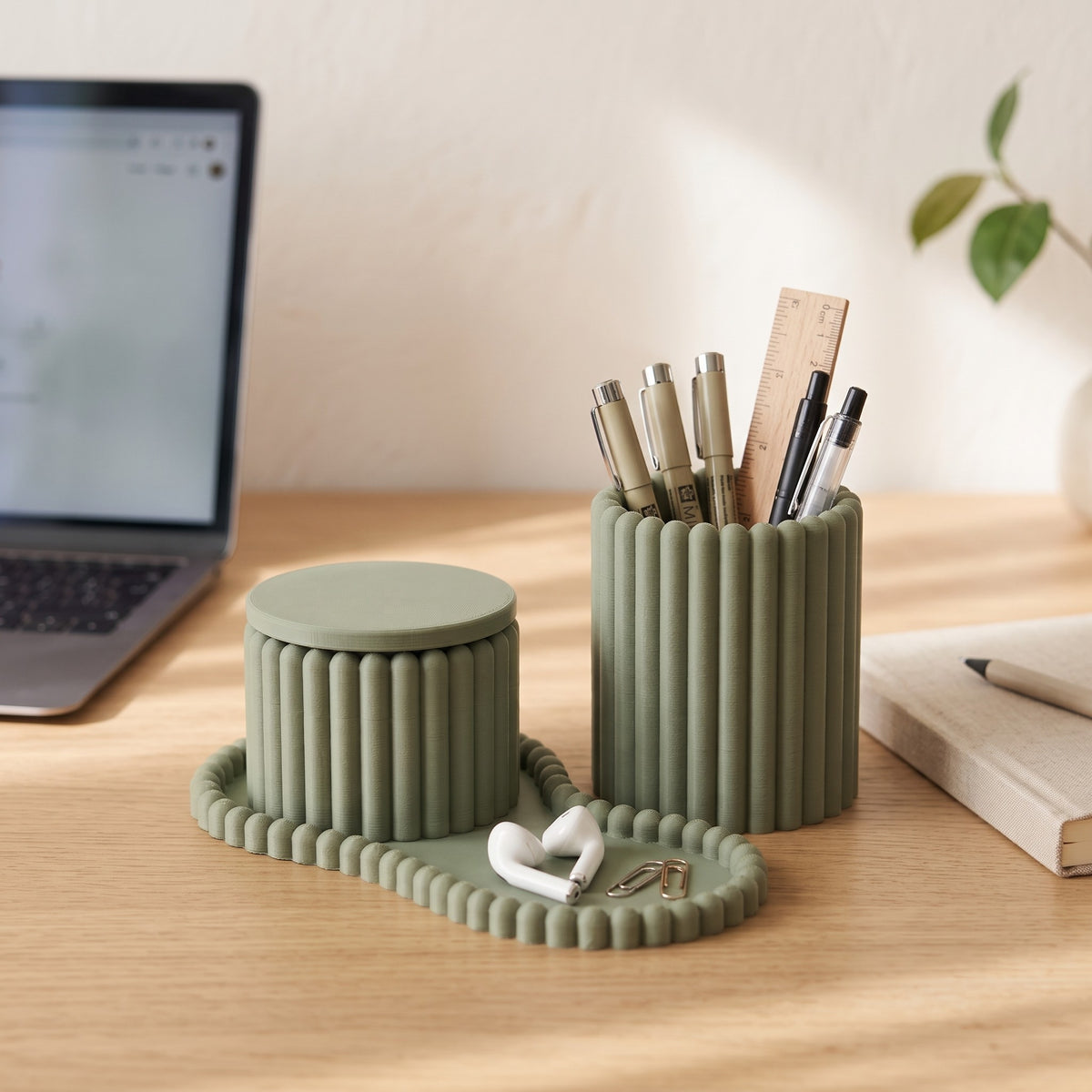 Ribblu organizer set on an oak desk holding pens and earbuds