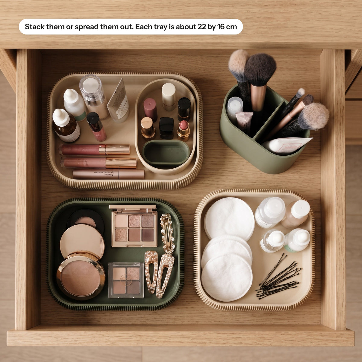 Stacksey trays spread out in a drawer holding makeup