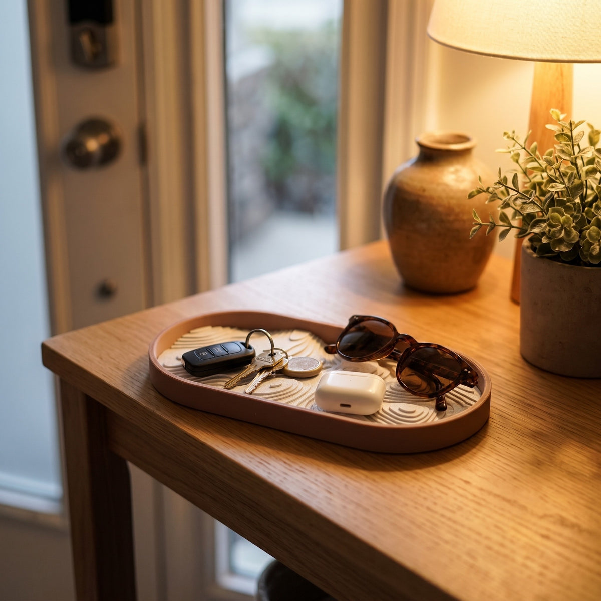 Topo tray by the front door holding keys, earbuds and sunglasses