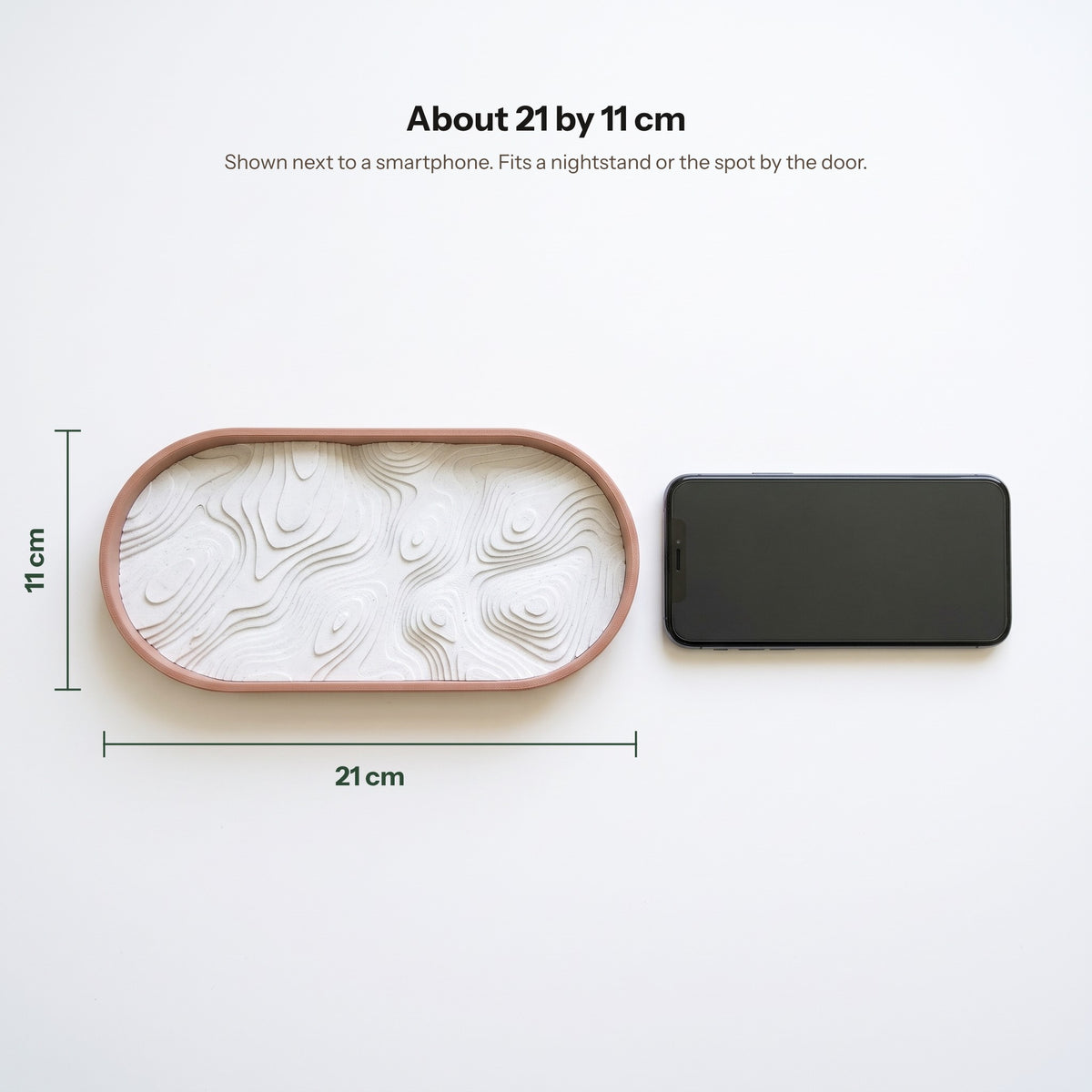 Topo tray next to a smartphone, about 21 by 11 cm