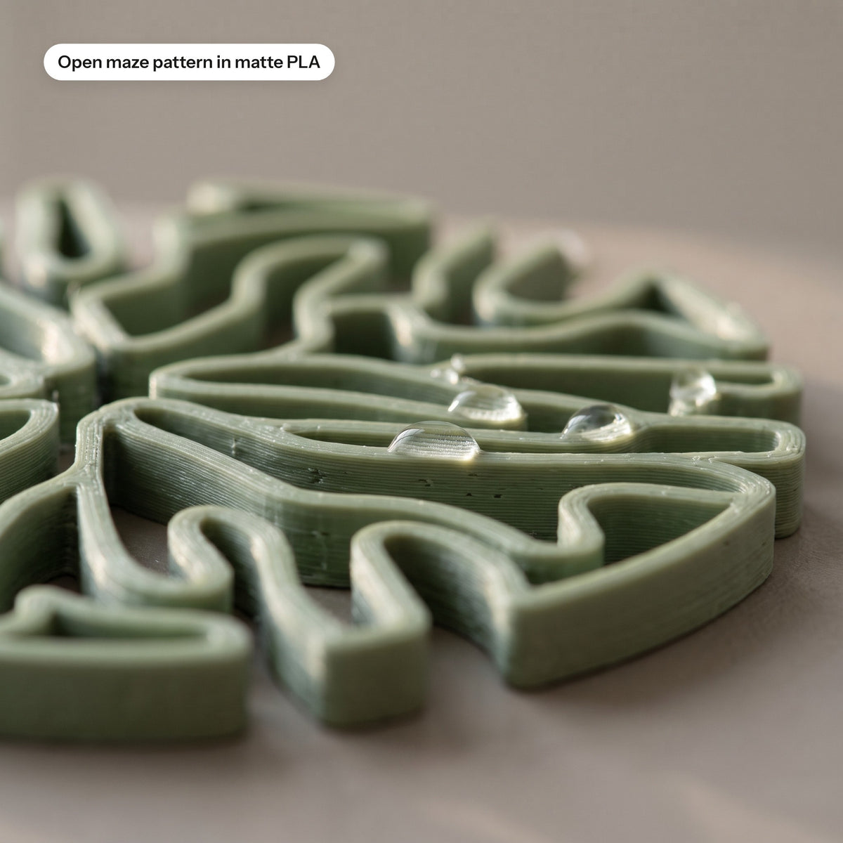 Close-up of the open maze pattern on a sage coaster